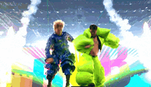 a man in a green suit is standing next to a woman in a blue dress on a stage