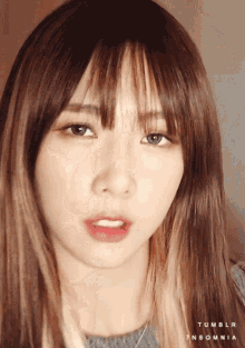a close up of a woman 's face with the words tumblr insomnia on the bottom right