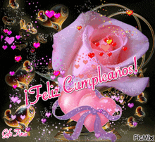 a pink rose with hearts around it and the words feliz cumpleanos