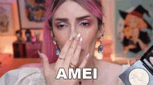a woman with pink hair is covering her face with her hand and the word amei is on the bottom right