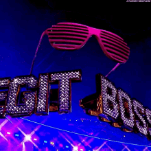 a pair of pink sunglasses hanging over the word edit