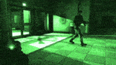a man in a military uniform is walking down a hallway in a dark room with a green light behind him .