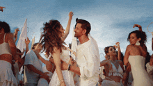 a man and a woman are dancing together in a crowd of people