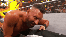 a man in a wrestling ring with a w logo on the bottom