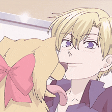 a girl with a pink bow on her head kisses a boy on the cheek