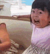 a little girl is making a surprised face with her mouth open