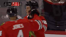 a hockey player in a red jersey with the number 4 on it