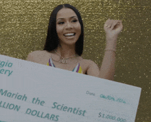 a woman blows a kiss while holding a check for $ 1,000,000