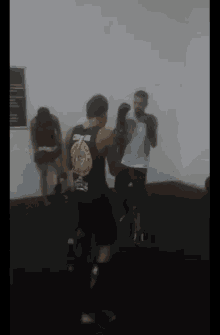 a man wearing a tank top that says ' ufc ' on it is boxing in a gym