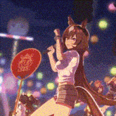 a girl with long brown hair is singing into a microphone while holding a fan .