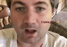 a close up of a man 's face with the words i love you on his face