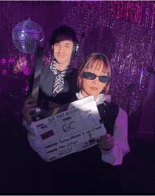 a man and a woman are holding a clapper board that says que mas quieres