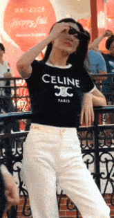 a woman wearing sunglasses and a celine paris t-shirt