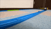 a toy train is going down a carpeted track