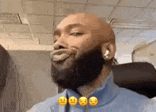 a man with a beard is making a funny face with his tongue out .