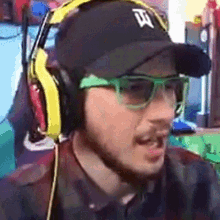 a man wearing headphones and a hat with a letter t on it .
