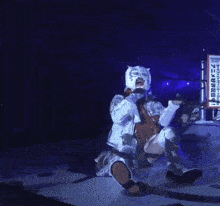 a wrestler in a tiger mask is sitting on the ground