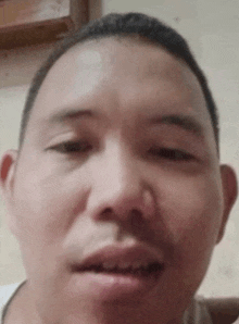 a close up of a man 's face with his mouth open and his teeth missing .