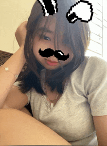 a girl with a fake mustache on her face looks at the camera