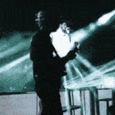 a man is playing a guitar and singing into a microphone