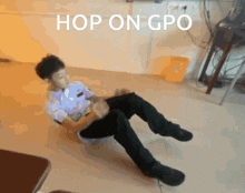 a boy is sitting on the floor with the words hop on gpo written above him