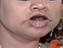 a close up of a woman 's face with a mask on her eyes .