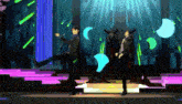 a couple of anime characters are dancing on a stage in a video game .