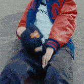 a person wearing a red and blue jacket with the letter n on the sleeves