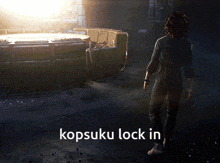 a woman is standing in a dark room with the words kopsuku lock in written below her
