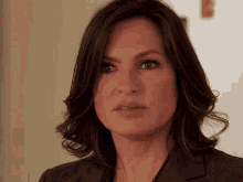 a close up of a woman 's face with dark hair