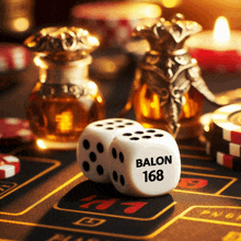 a pair of dice that say balon 168 sit on a table