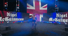 a wrestler named nigel mcguinn is on stage