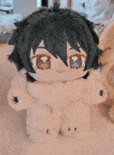 a stuffed animal that looks like a dog with a scarf around its neck