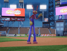 a cartoon character stands on a baseball field in front of a sign for kaak