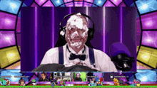 a man with whipped cream on his face is sitting in front of a microphone in a video game