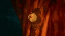a red flower with flames coming out of it is surrounded by a dark background