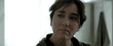 a close up of a woman 's face with a serious expression