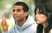 a man and a woman are looking up at something