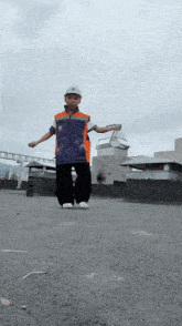 a boy wearing a hard hat and a blue shirt that says ' ucsd ' on the front
