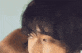 a close up of a person 's face with black hair