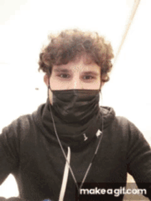 a man wearing a black face mask and ear buds with make a git.com at the bottom