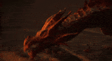 a man with a bow and a sword stands in front of a fire in the desert