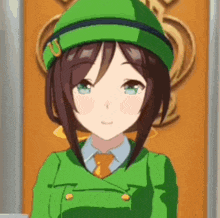 a close up of a girl wearing a green hat and a green jacket .