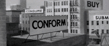a black and white photo of a city with a sign saying conform