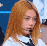 a close up of a woman wearing a microphone and a tie