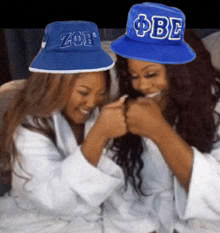 a woman wearing a blue hat with the letters obe on it