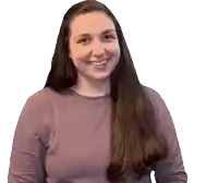 a woman wearing a purple shirt is smiling and looking at the camera