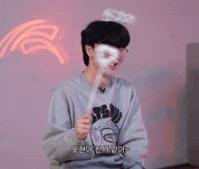 a man wearing glasses and a sweatshirt that says ' bts ' on the front
