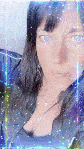 a close up of a woman 's face with sparkles around it