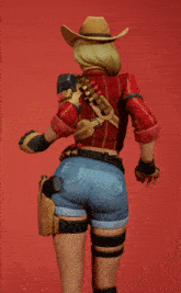a woman in a cowboy hat is holding a gun in her right hand